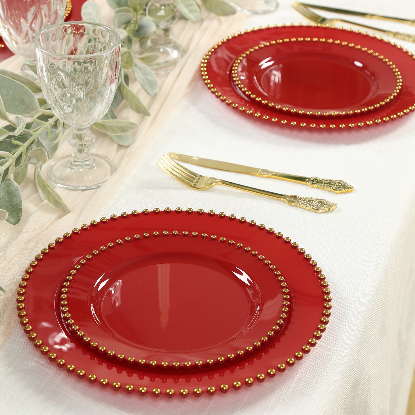 Red plastic dessert plates with gold beaded rim, perfect for parties.