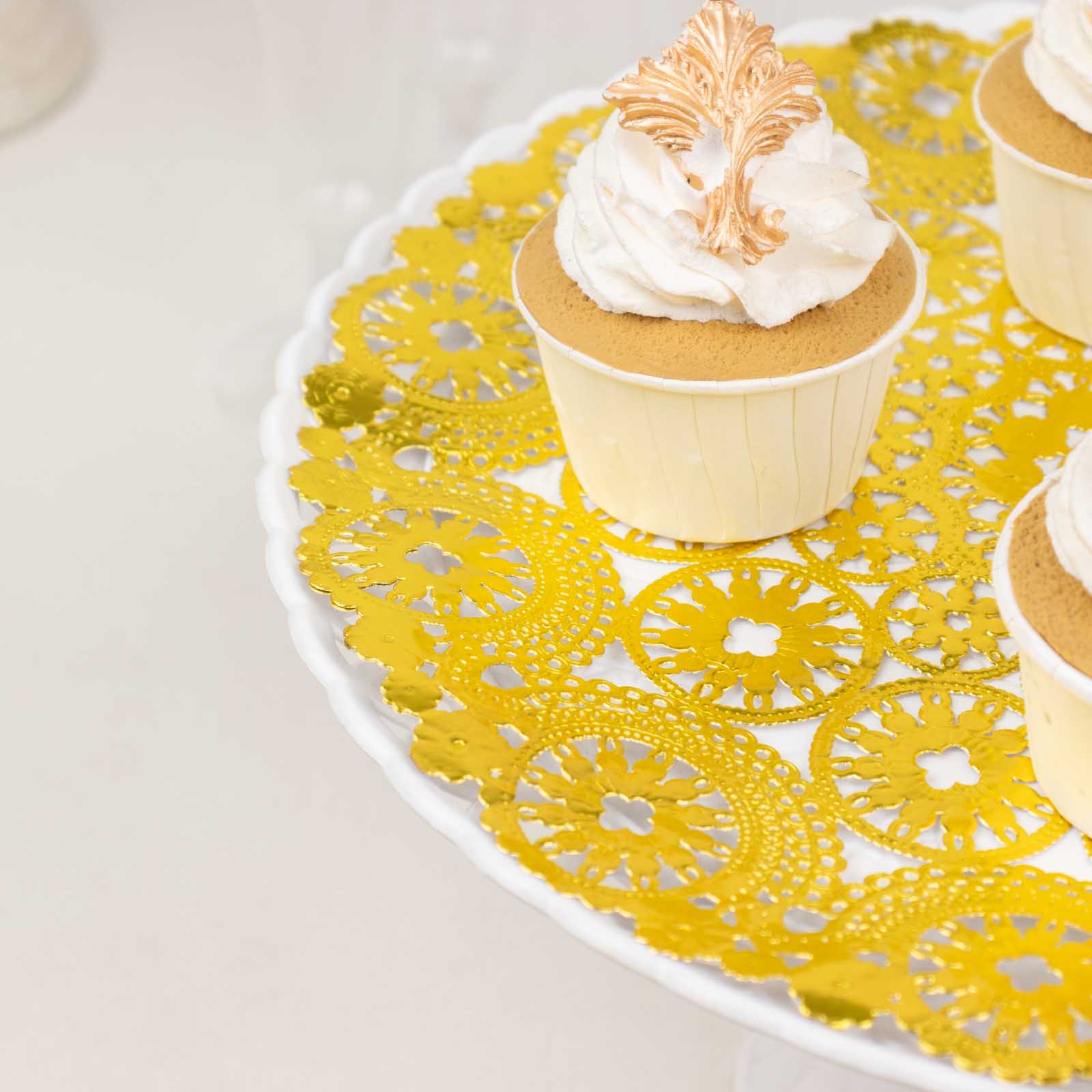 Metallic gold paper lace doilies on a cake stand with cupcakes.