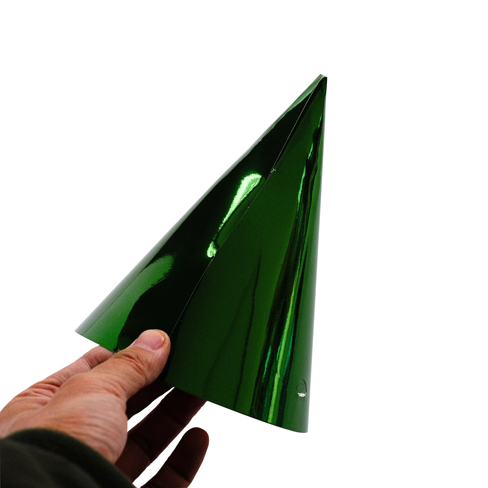 Green metallic foil cone party hat held in hand.