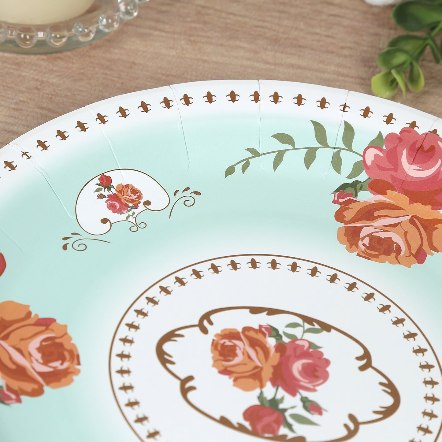 Light turquoise floral paper dinner plate with rose print.