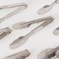 Silver metal kitchen tongs with scalloped edges, 9.5 inches long.