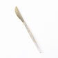 Gold glittered disposable knife with plastic silverware cutlery.