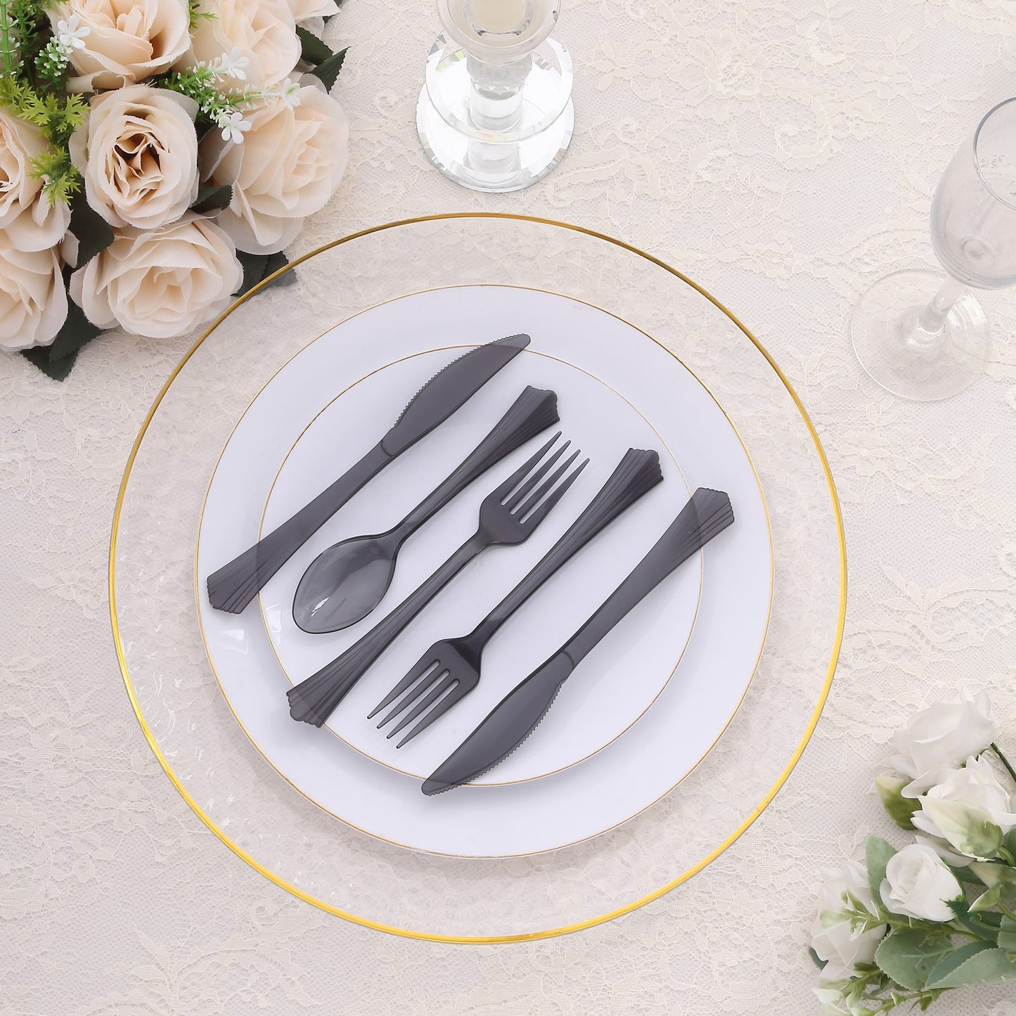 Transparent black disposable cutlery set on a table with elegant decor.