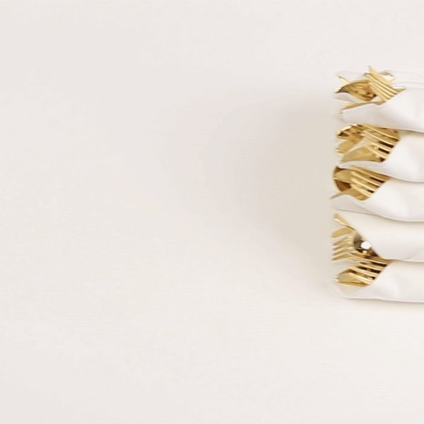 Gold disposable cutlery set with white napkins, perfect for events.