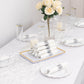 Set of 24 silver disposable cutlery with white napkins on a table.