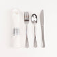 Silver disposable cutlery set with white napkin.