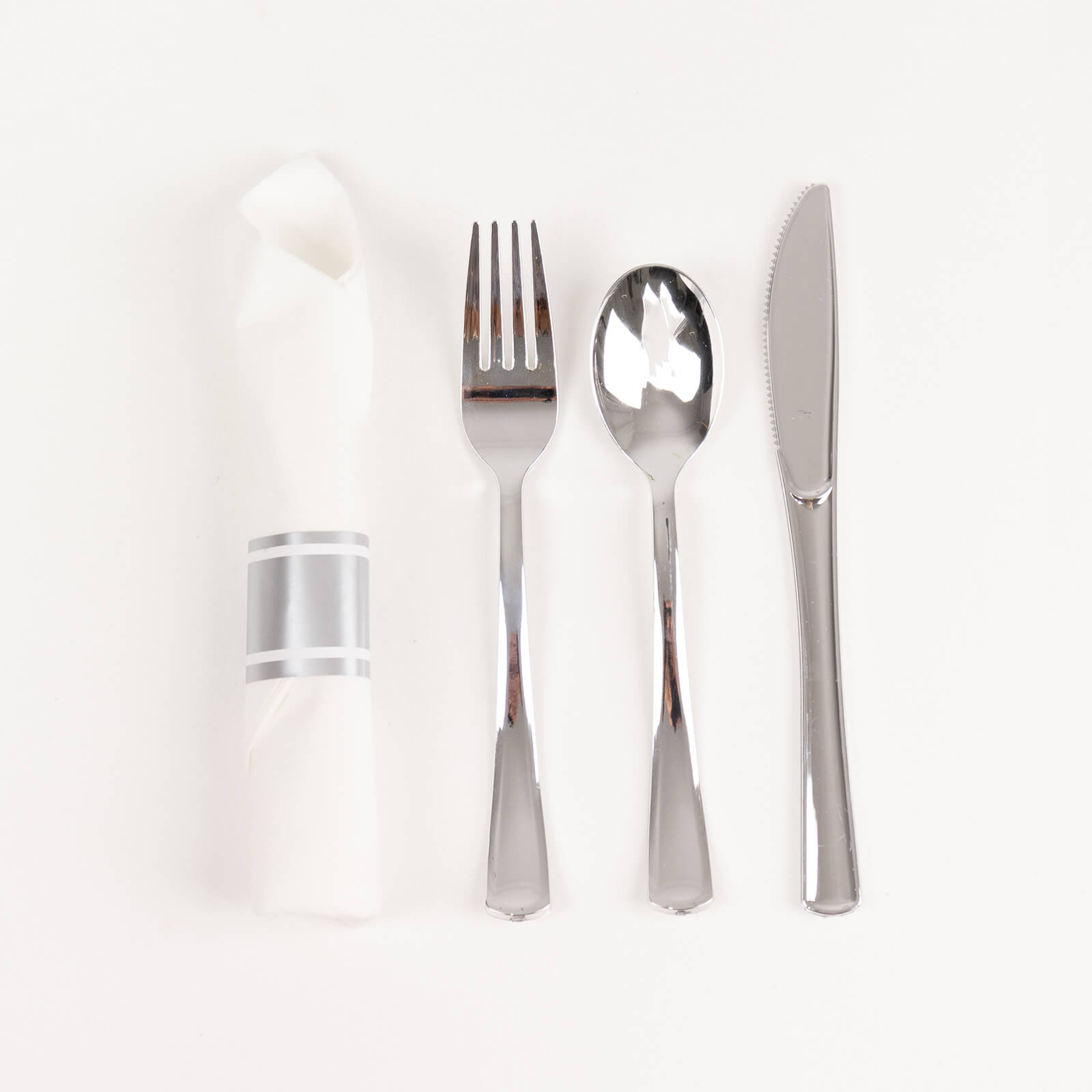 Silver disposable cutlery set with white napkin.