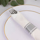 Silver disposable cutlery set with white napkin on a plate.