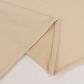 Beige spandex 4-way stretch fabric roll, perfect for DIY crafts.
