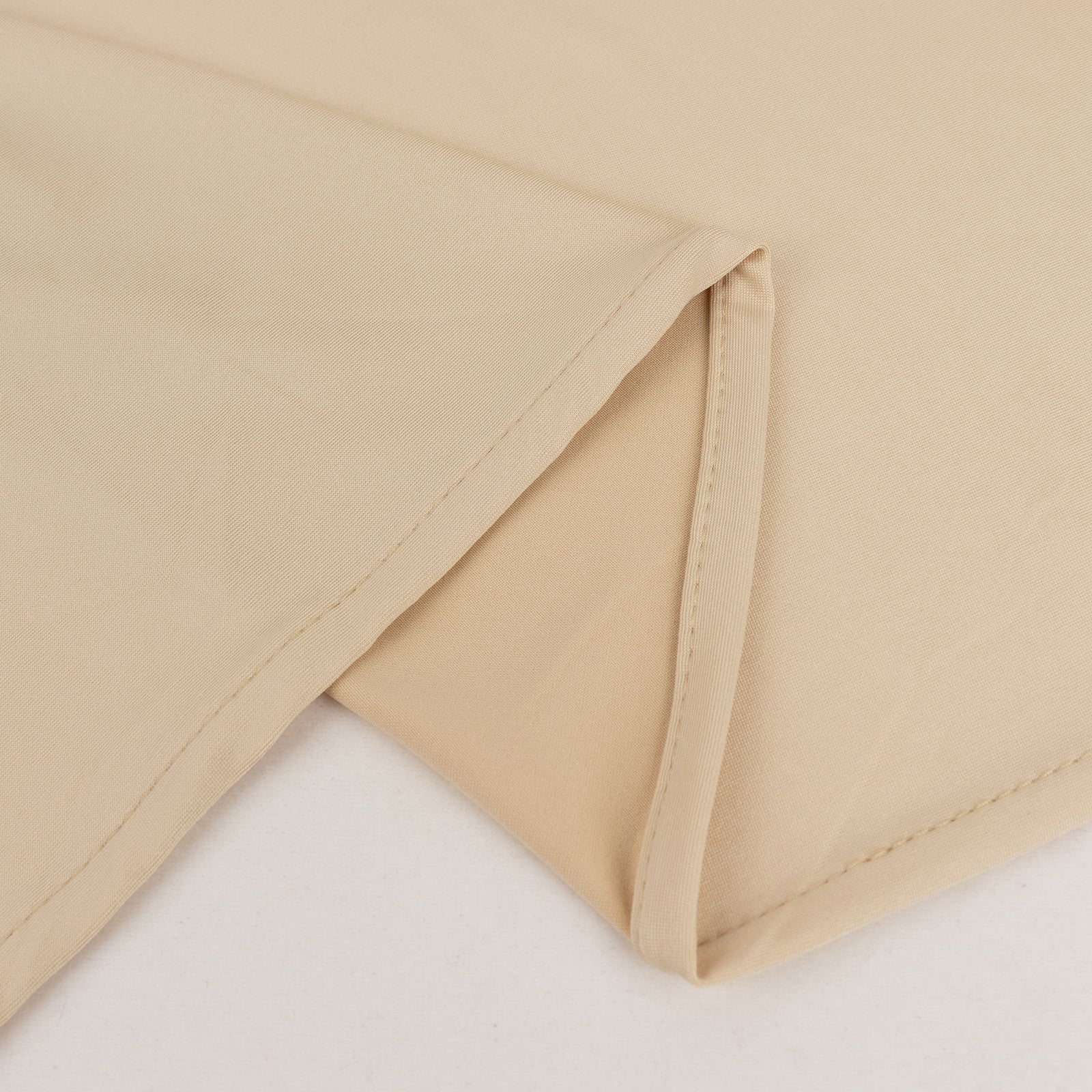 Beige spandex 4-way stretch fabric roll, perfect for DIY crafts.