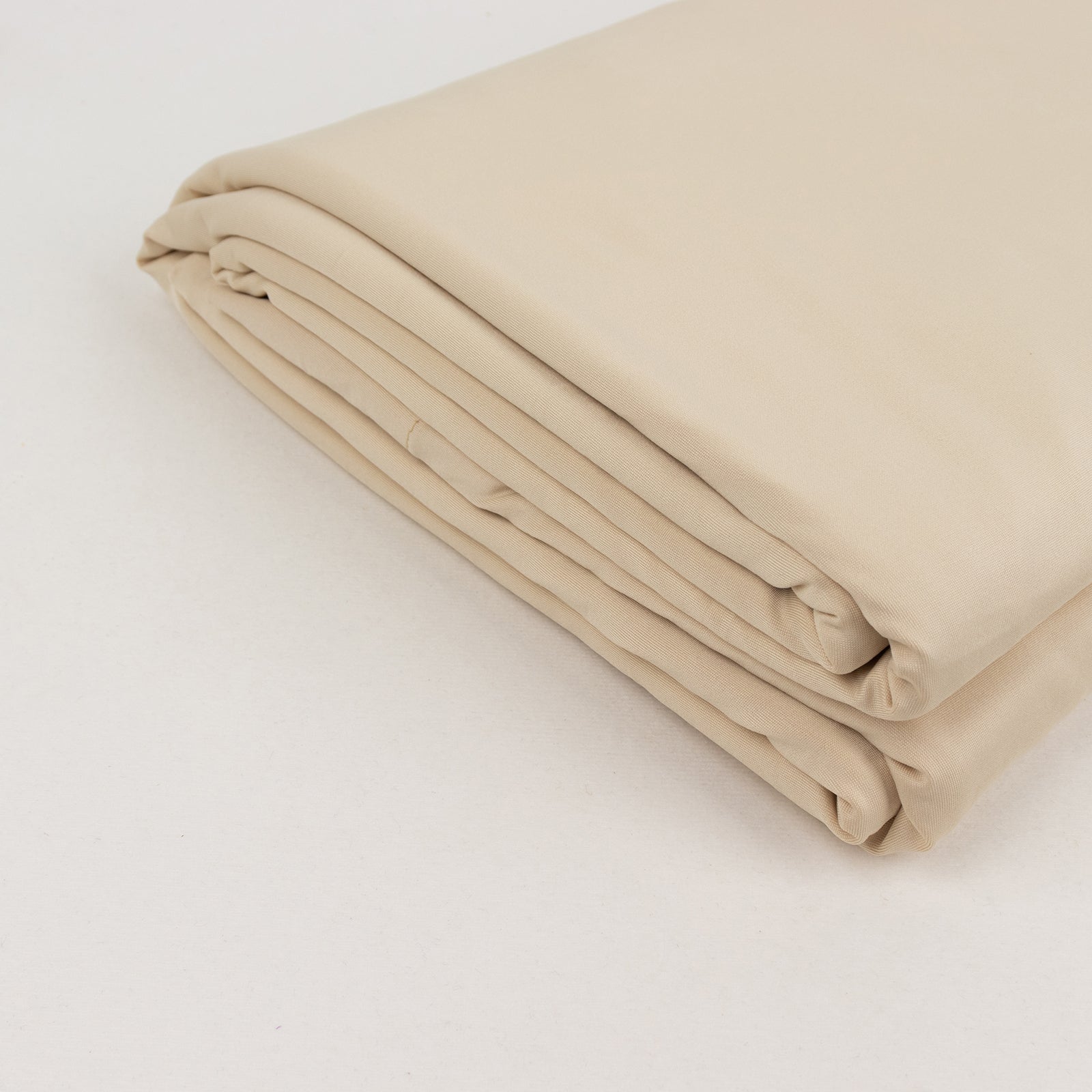 Beige spandex 4-way stretch fabric roll, 60"x10 yards, perfect for DIY crafts.