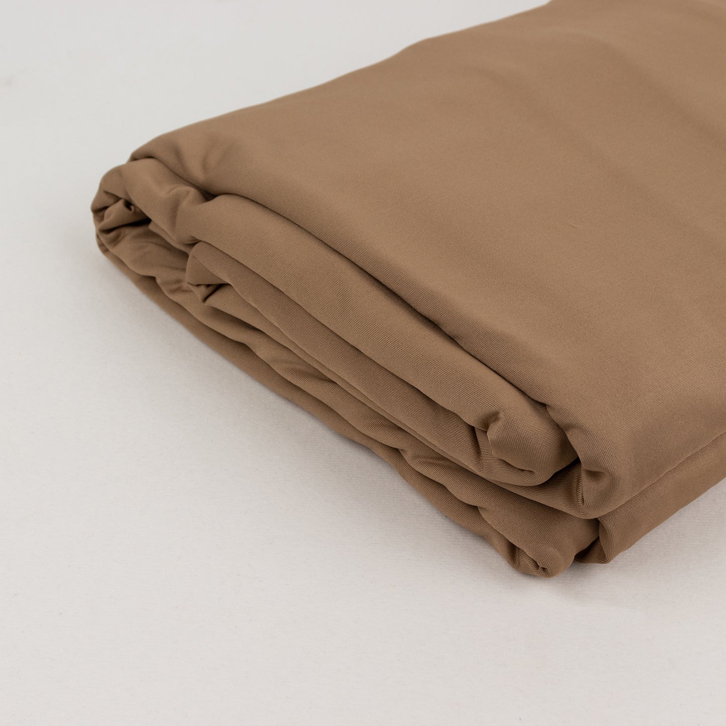 Taupe 4-way stretch spandex fabric roll, 60"x10 yards, perfect for DIY crafts.