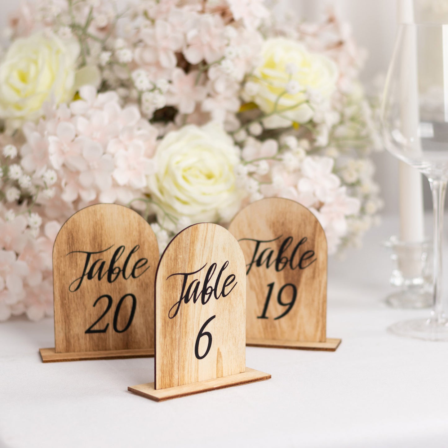 Natural wood table numbers for weddings, featuring numbers 1-20.