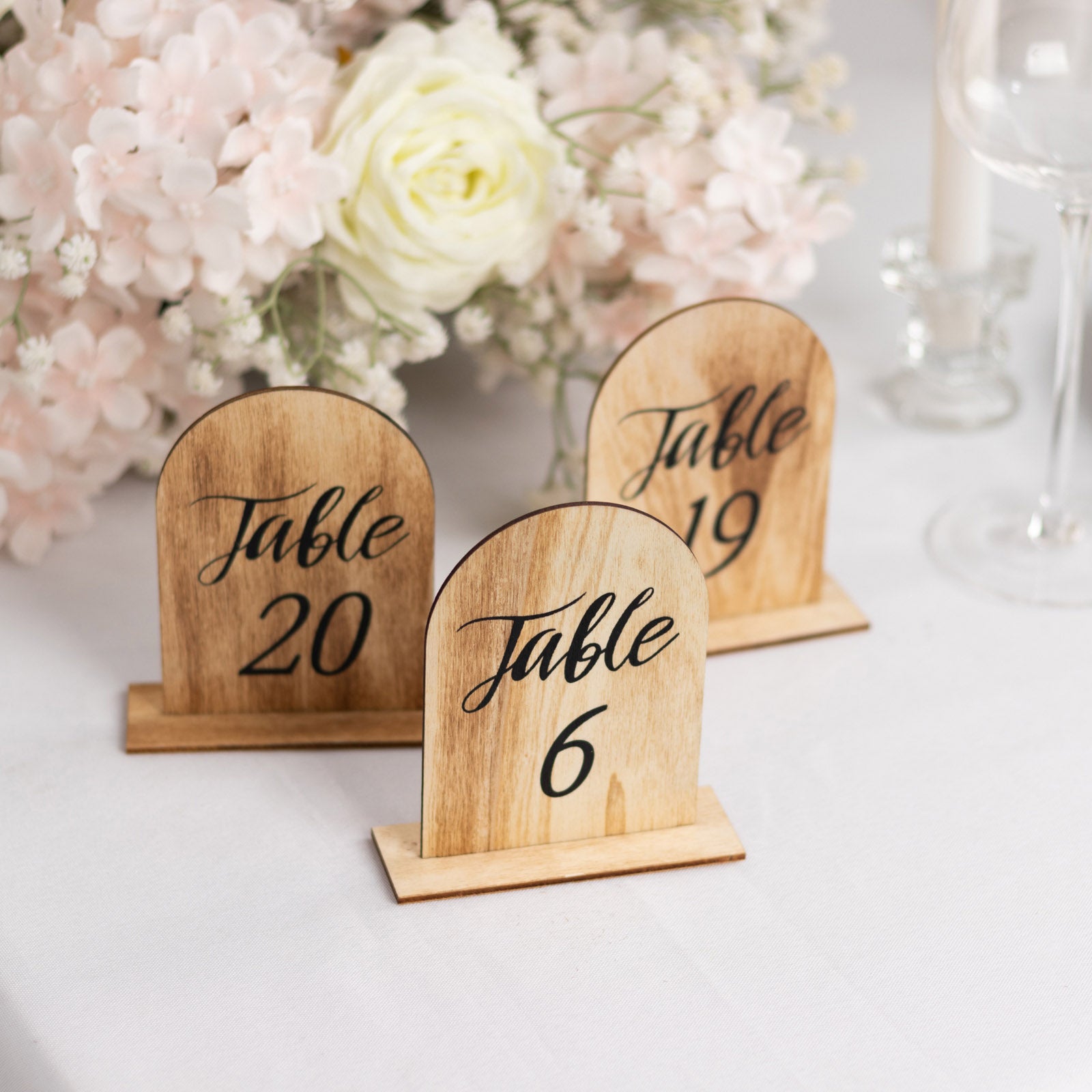Natural rustic wooden arch table numbers for weddings and events.