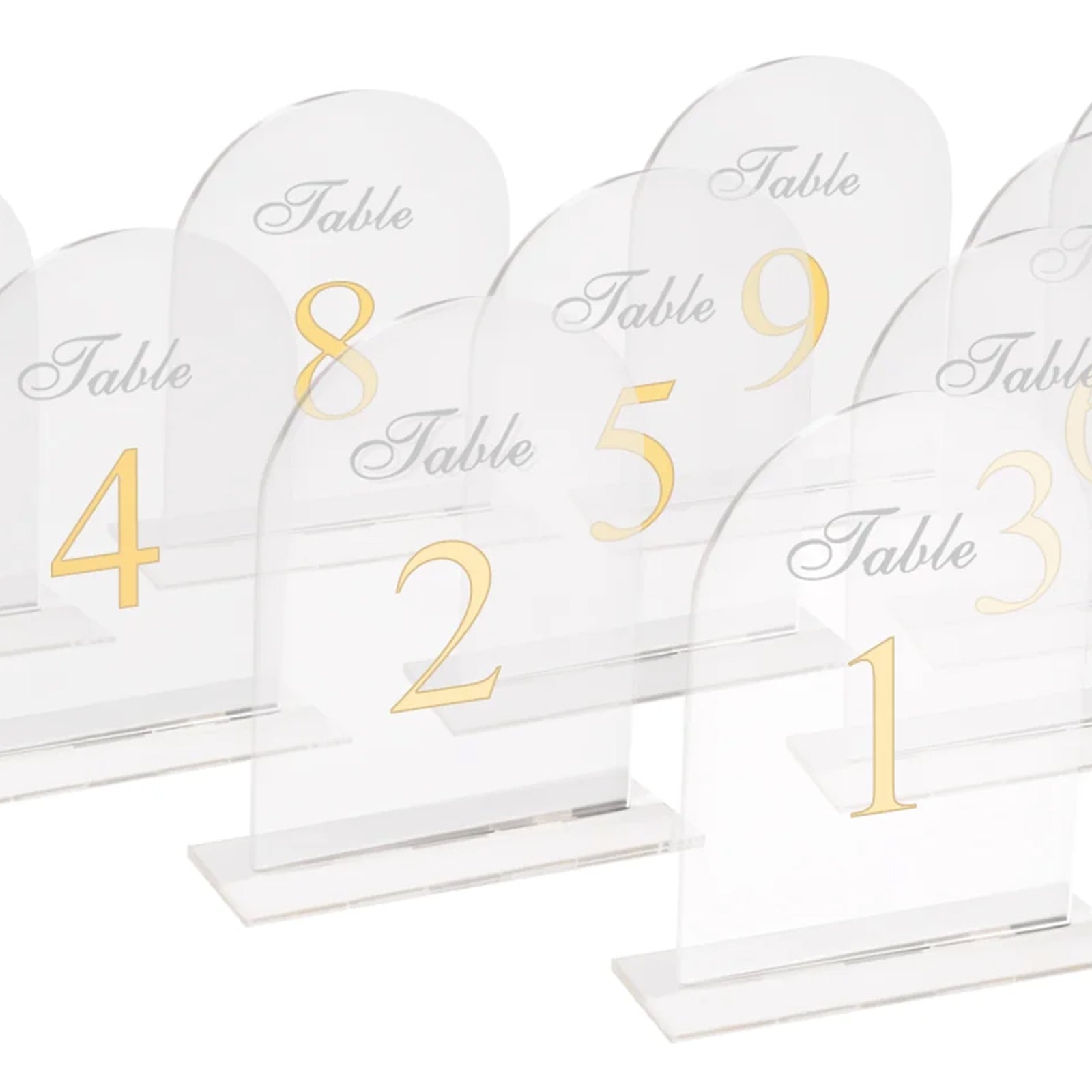 Clear arch acrylic table numbers with gold print for weddings.