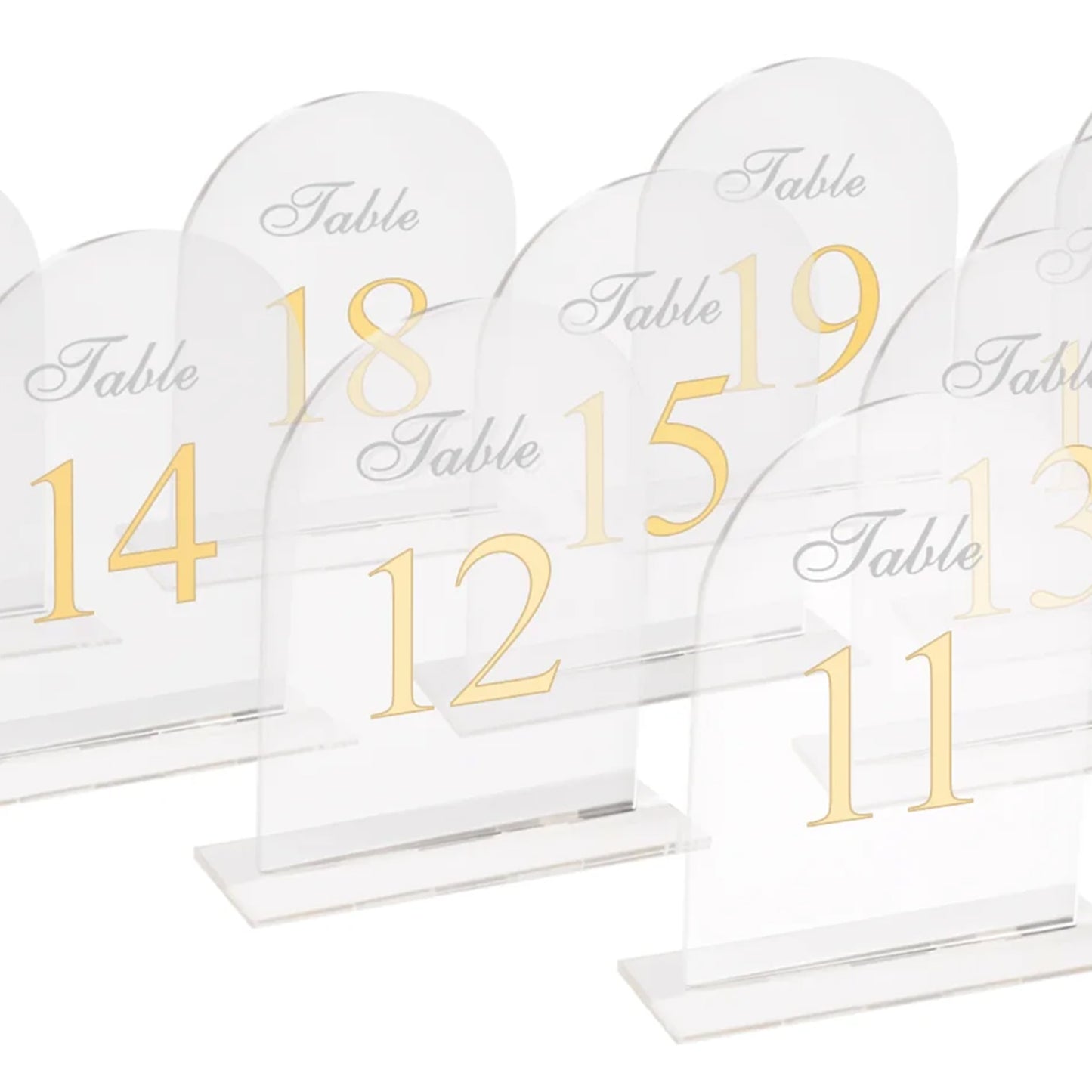 Clear arch acrylic table numbers with gold print for weddings.