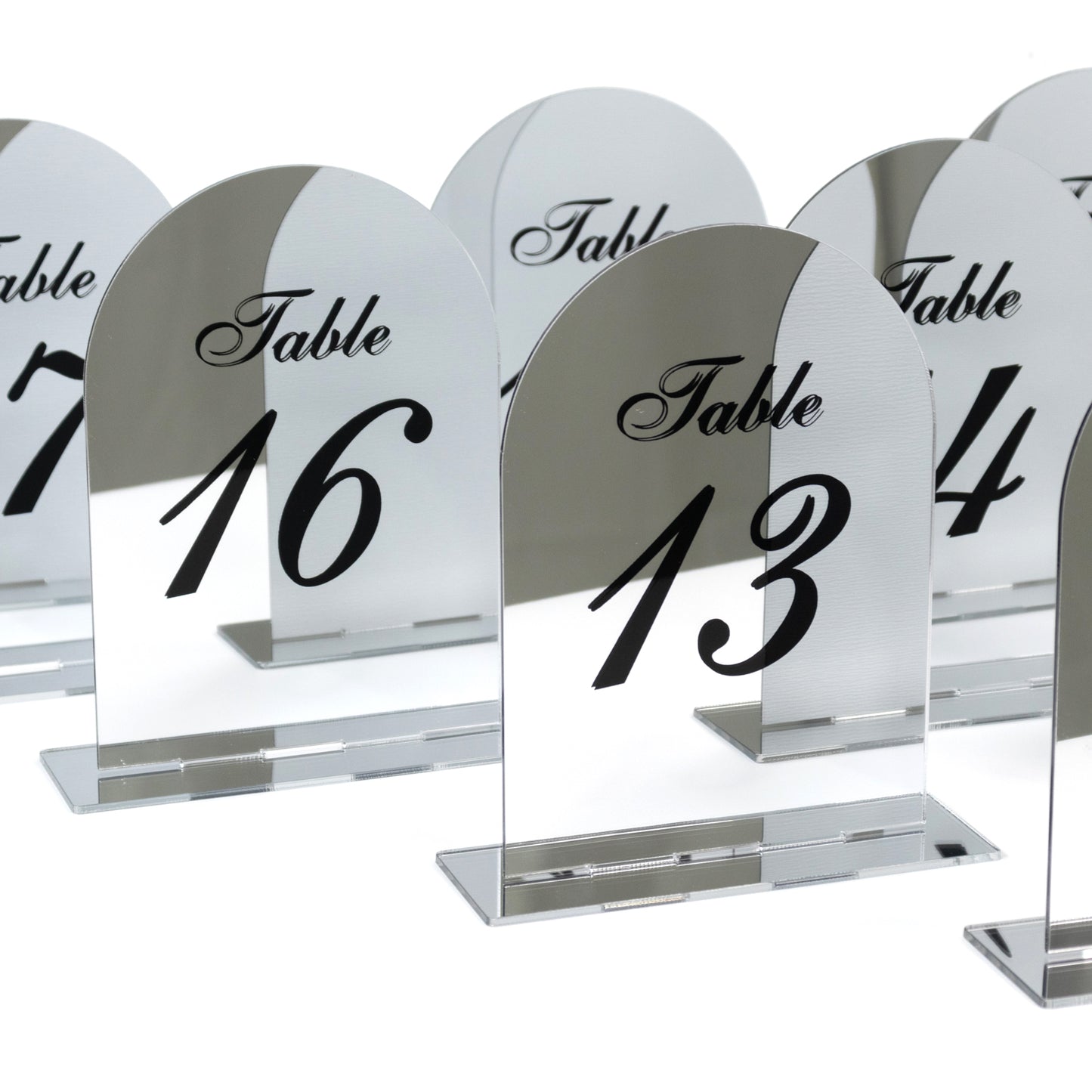 Silver mirror table numbers 11-20 with black print and stands.