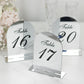 Silver mirror arch table numbers with black print for weddings.