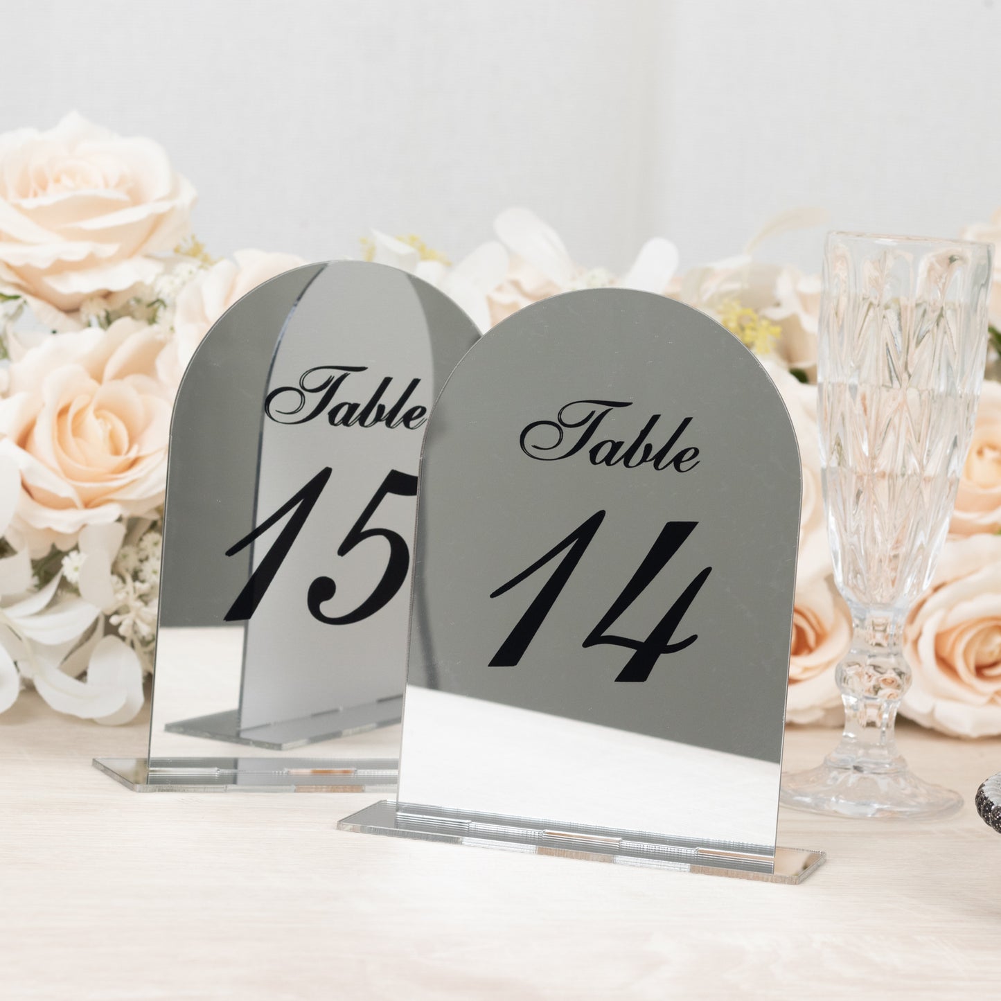 Silver mirror arch table numbers 14 and 15 with black print.