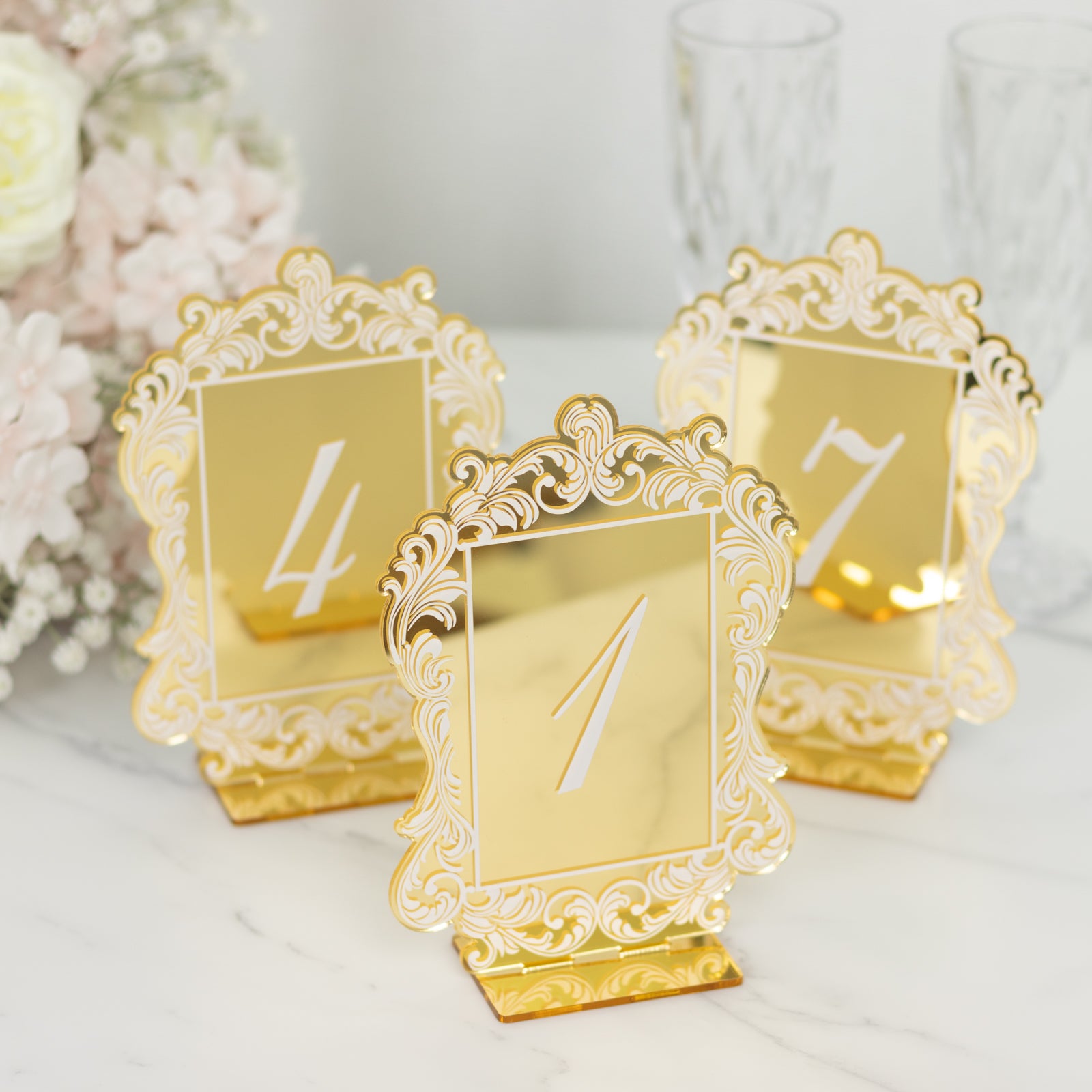 Gold mirror arch table numbers with white print and baroque lace border.