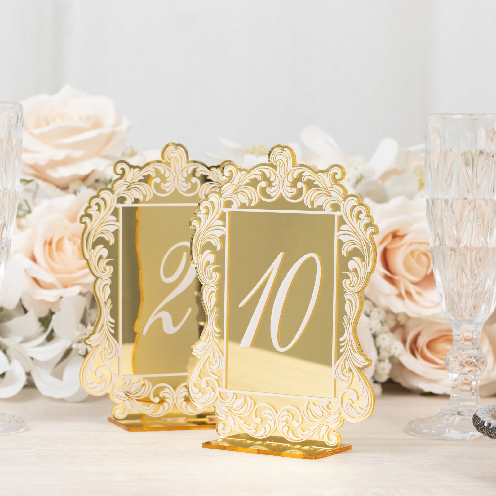 Gold mirror table numbers with baroque lace border for wedding reception.