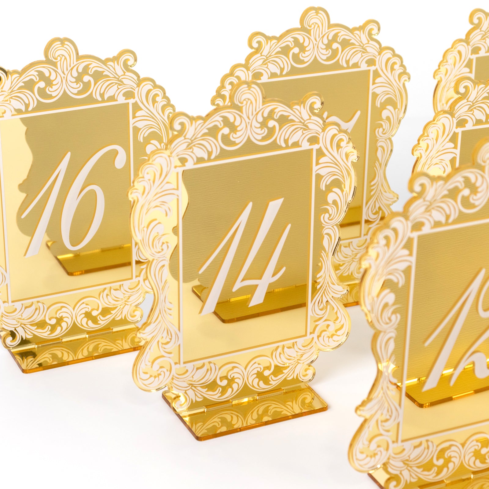 Gold mirror arch table numbers with white print and baroque lace border.