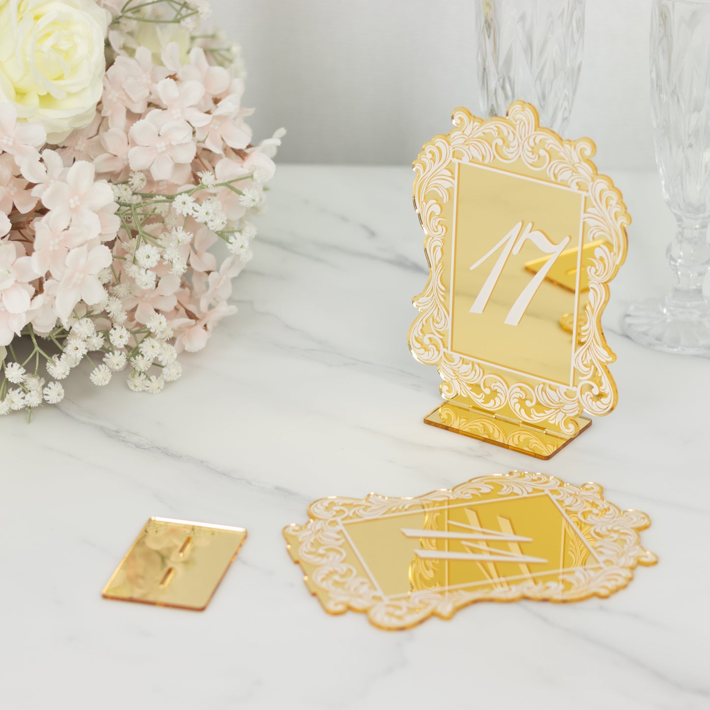 Gold mirror arch table number 17 with white print and baroque lace border.
