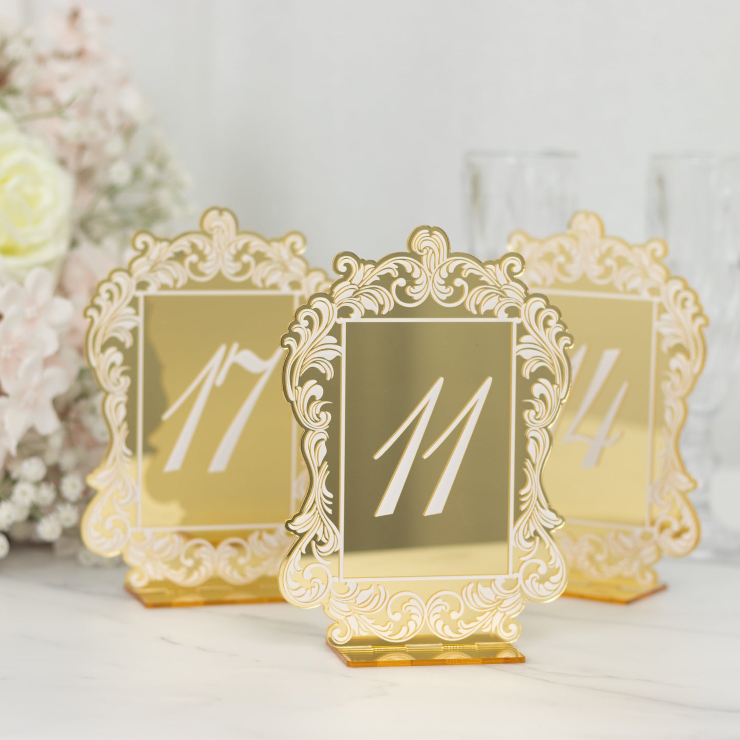 Gold mirror arch table numbers with baroque lace border for weddings.