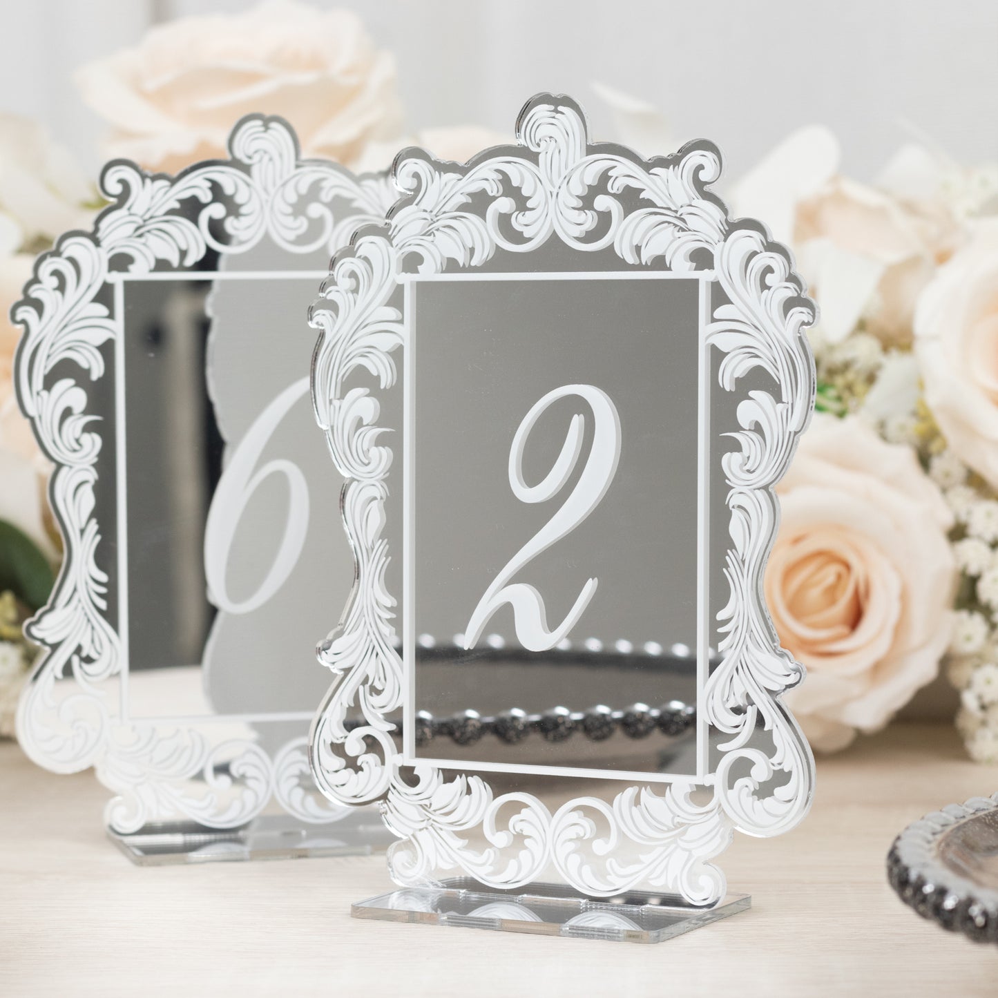 Silver mirror table numbers with baroque lace border, elegant wedding decor.
