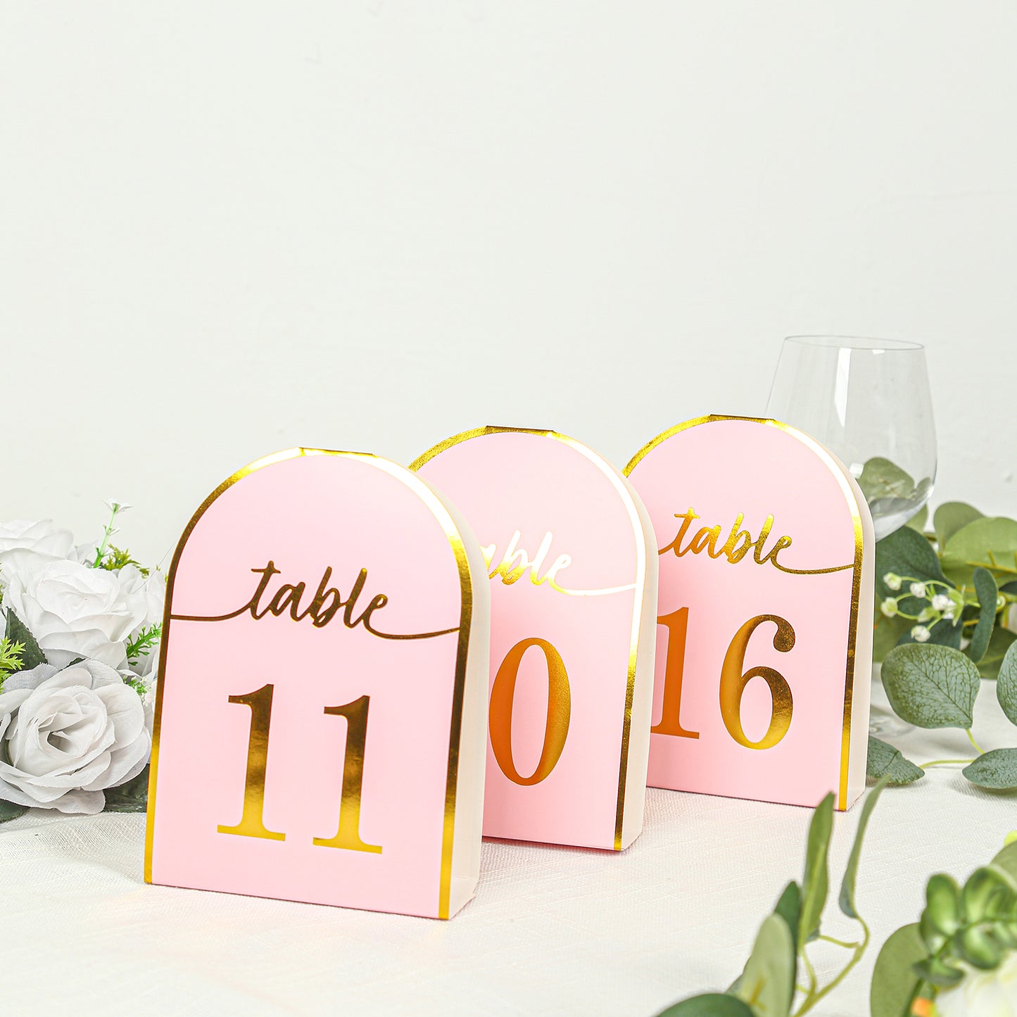 Blush pink disposable table numbers with metallic gold foil, numbers 1-25.