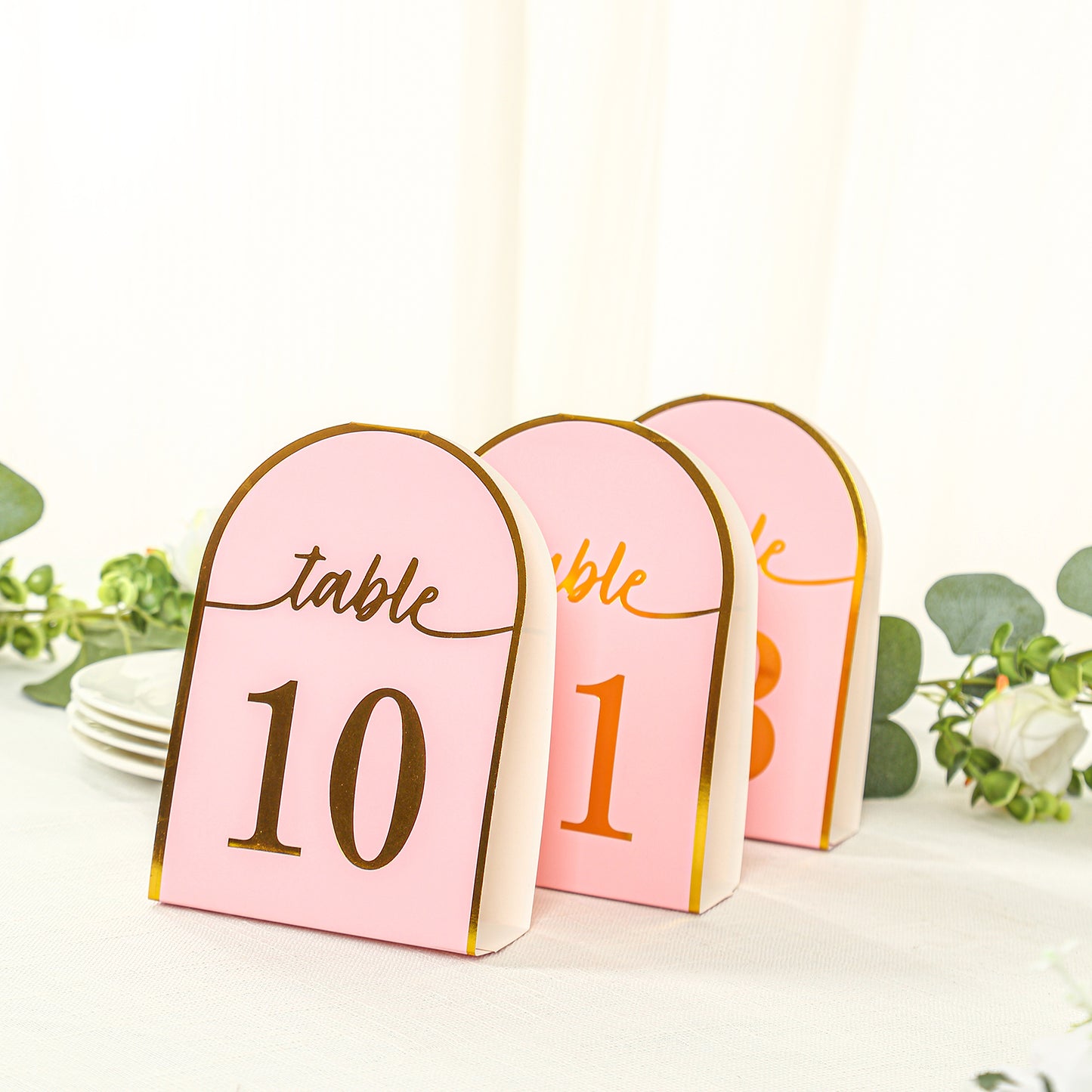 Blush pink table numbers with metallic gold foil numbers 1-25.