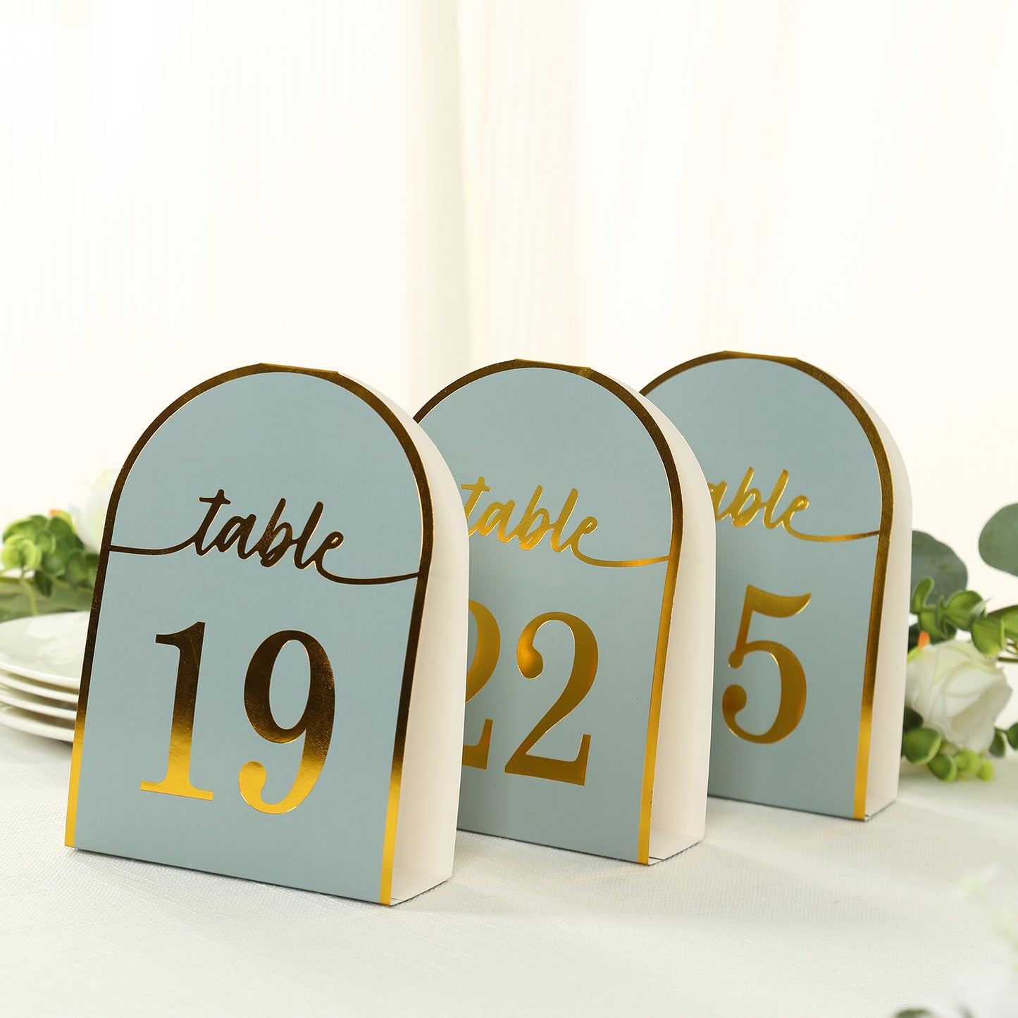 Dusty blue table numbers with metallic gold foil, numbers 1-25.