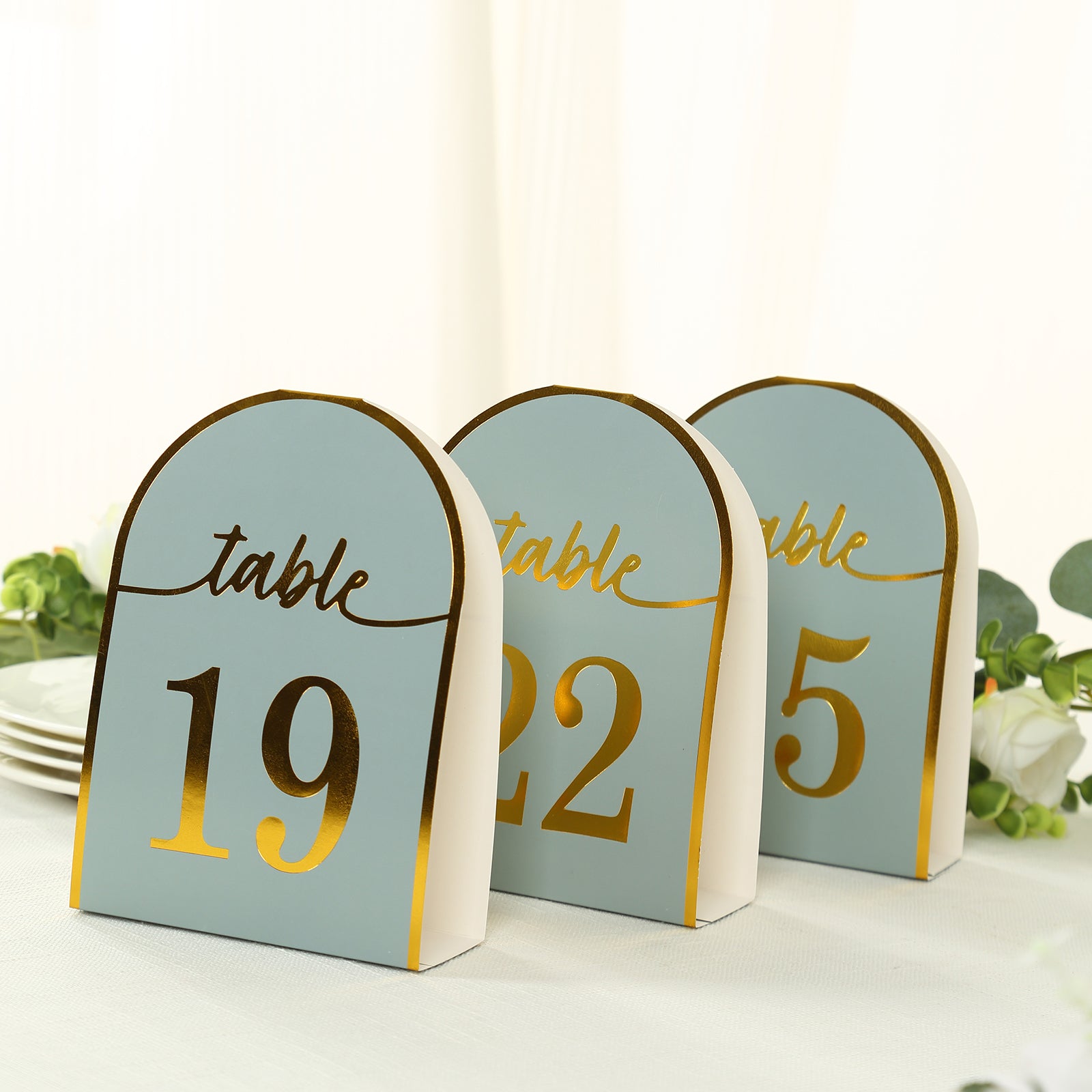 Dusty blue table numbers with metallic gold foil, numbers 1-25.