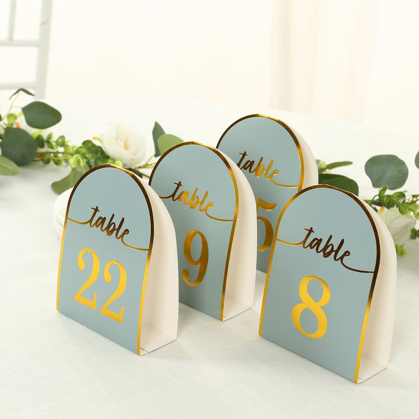 Dusty blue table numbers with metallic gold foil numbers 1-25.