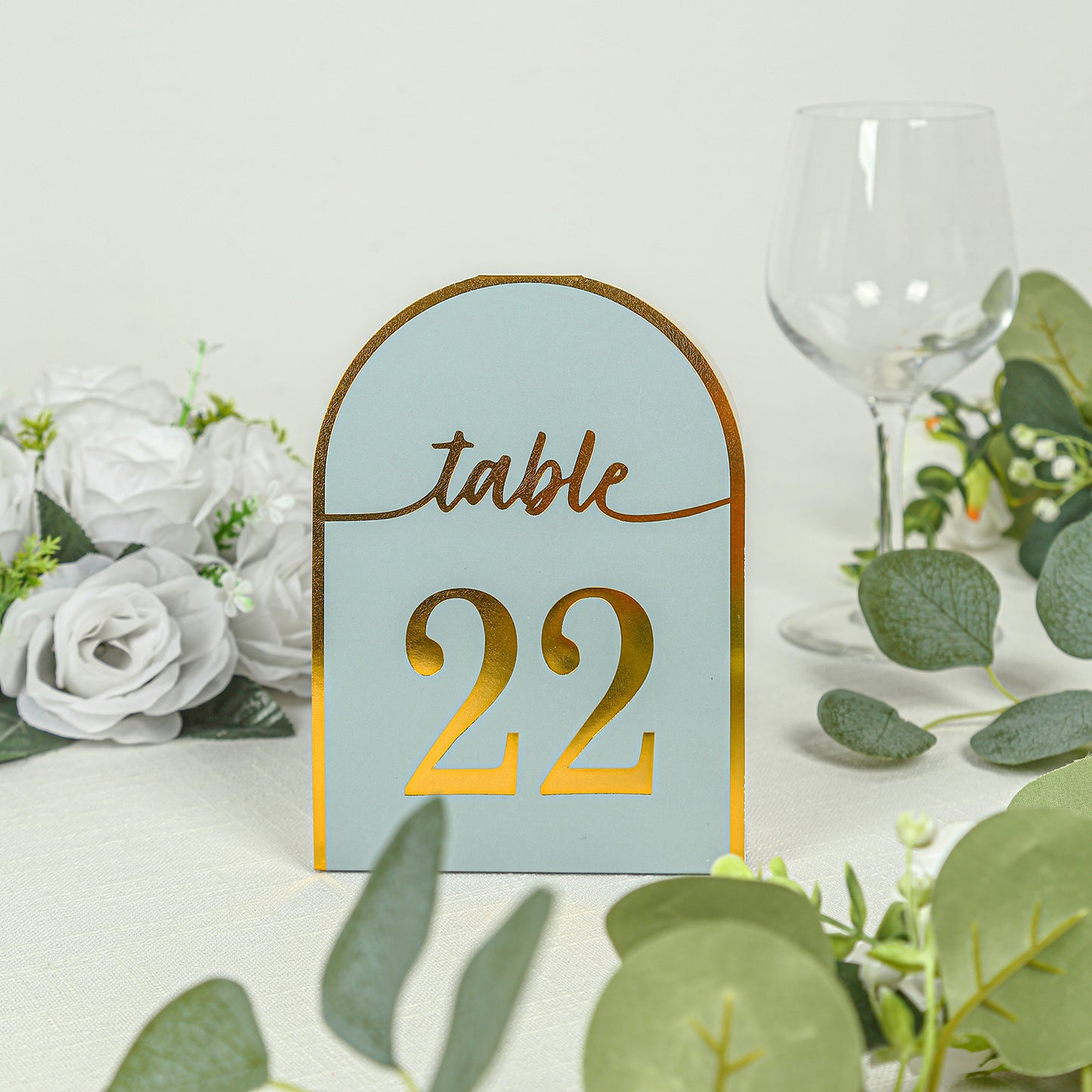 Dusty blue table number card with metallic gold foil number 22.