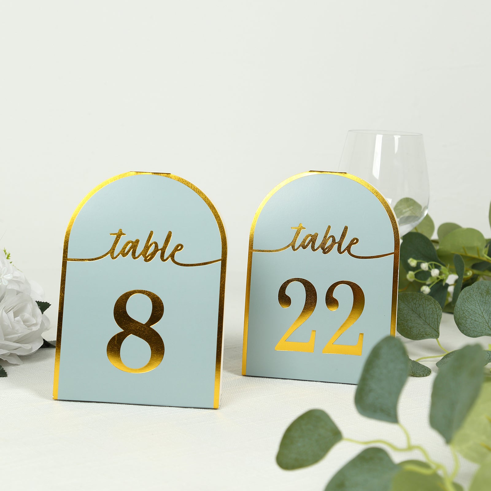 Dusty blue table numbers with gold foil, displaying numbers 8 and 22.