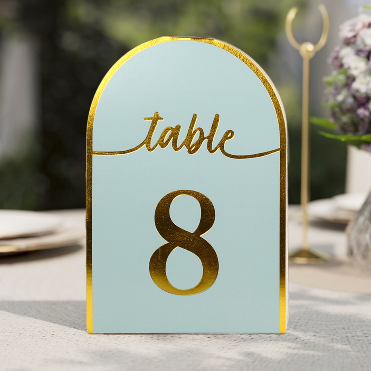 Dusty blue table number card with metallic gold foil number 8.