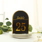 Black and gold double-sided table number 25 on a plate.