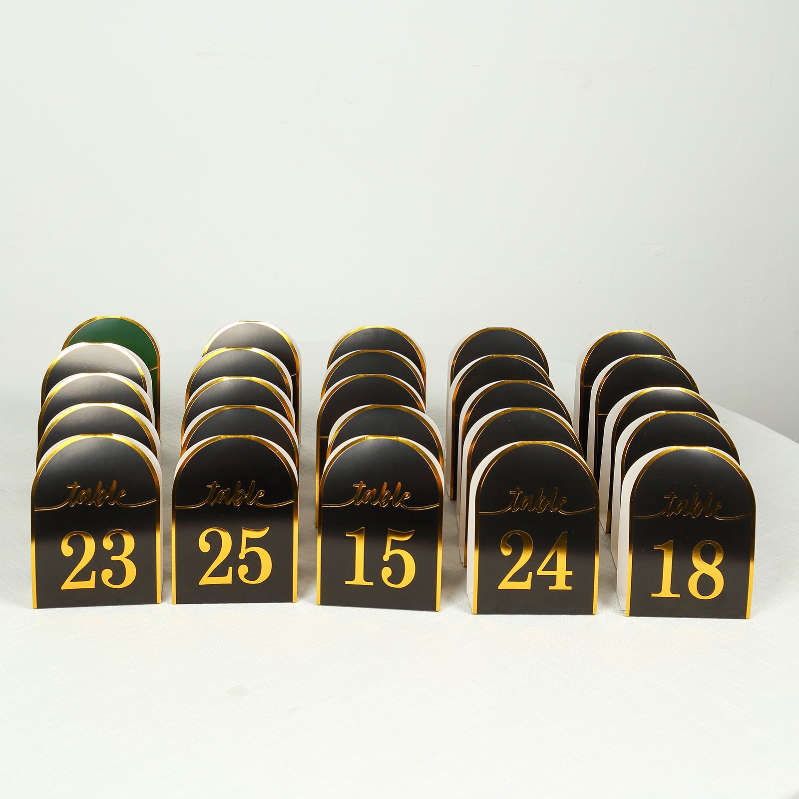 Black and gold disposable table numbers, 25-pack, double-sided.