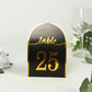 Black and gold disposable table number card, standing with number 25.
