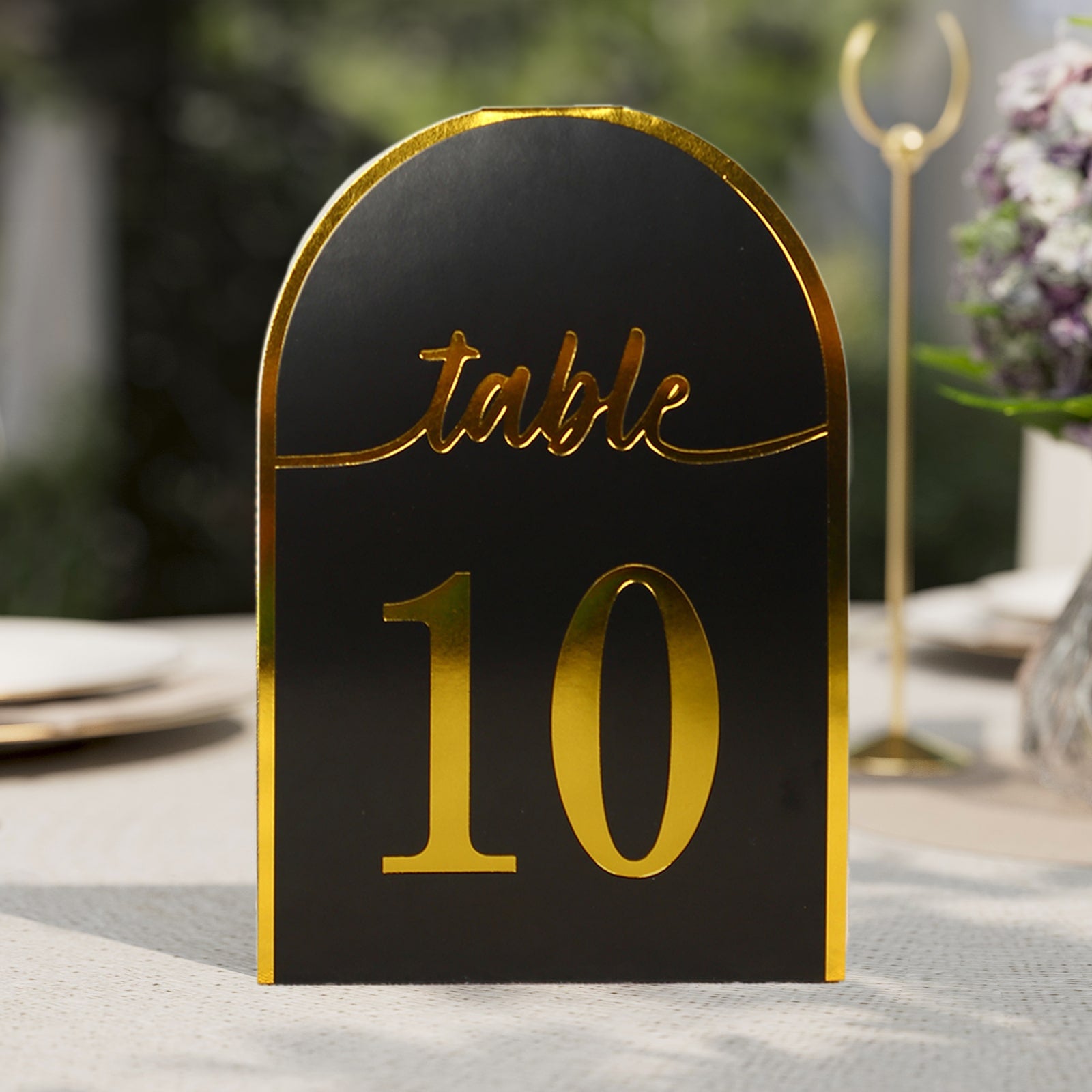 Black and gold double-sided table number card displaying "table 10".