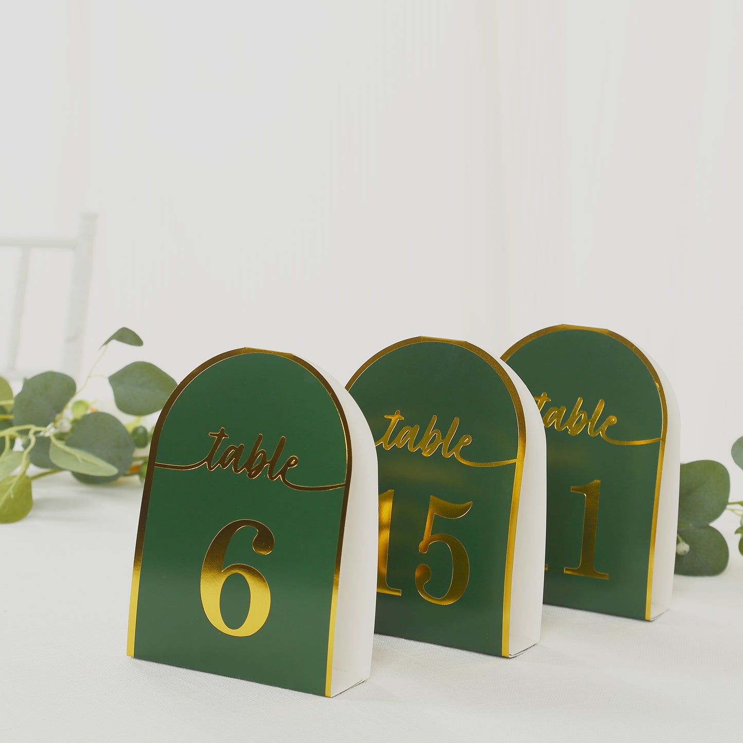 Hunter emerald green table numbers with metallic gold foil numbers.