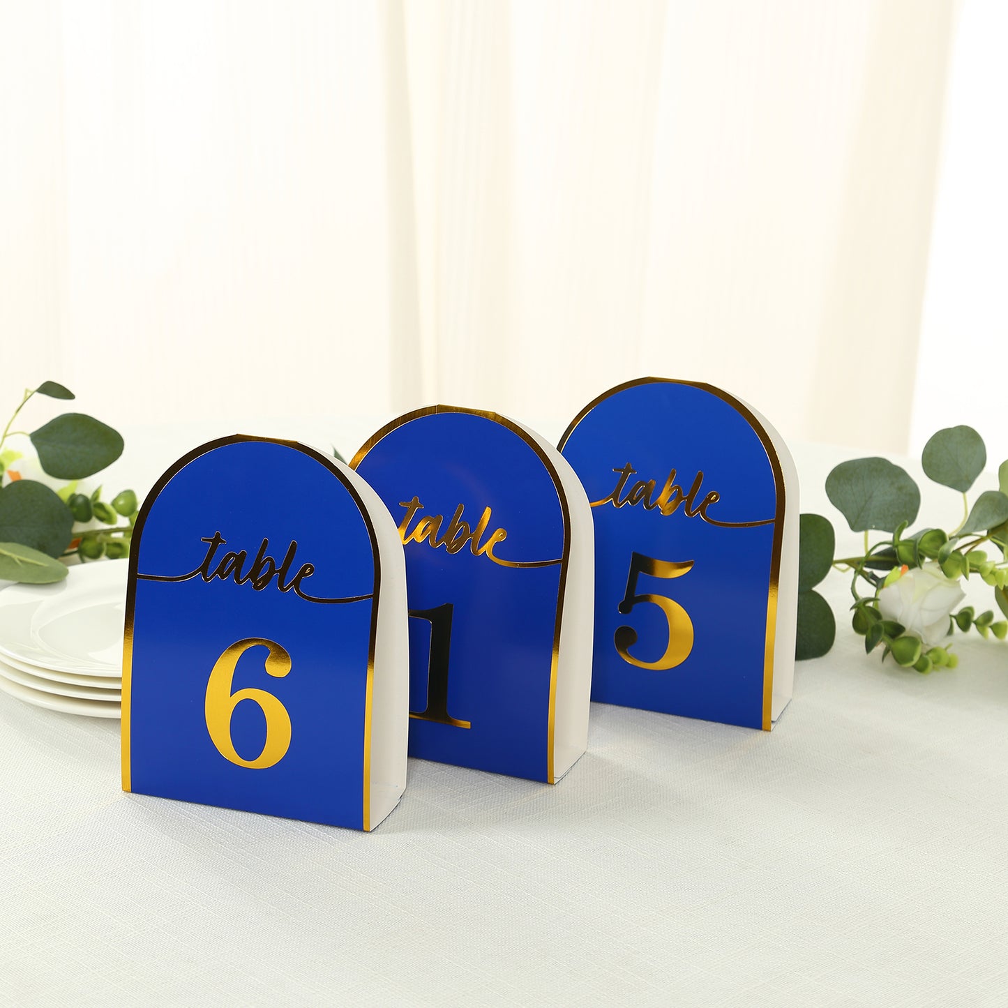 Royal blue double-sided table numbers with metallic gold foil numbers.