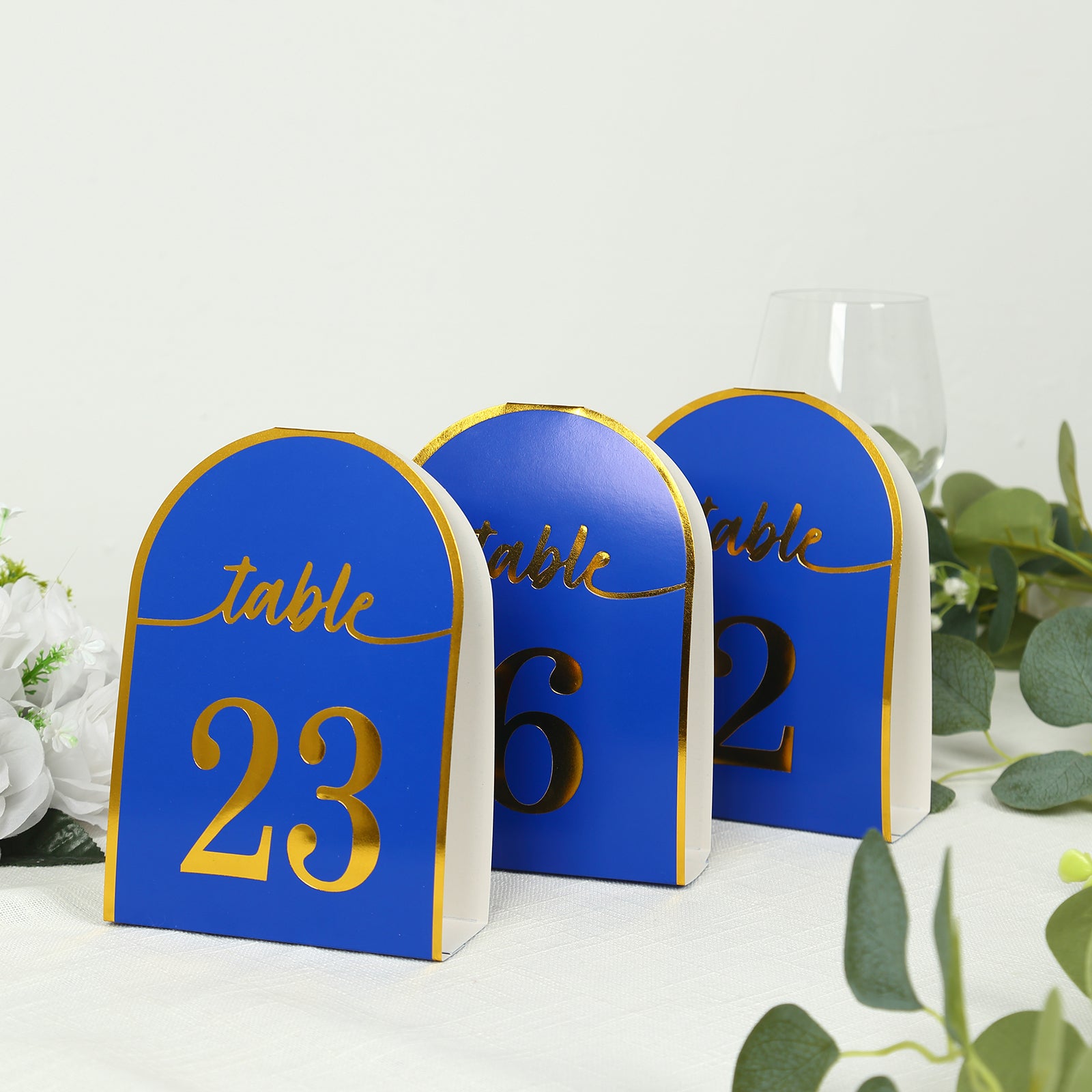 Royal blue disposable table numbers with metallic gold foil numbers 1-25.