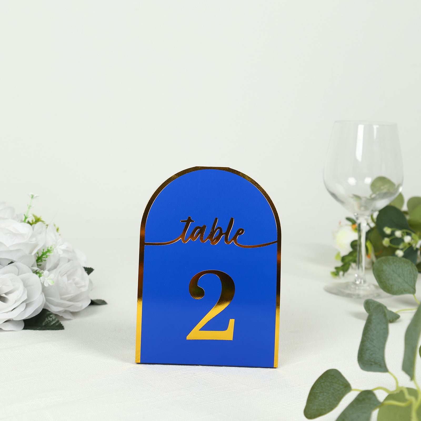 Royal blue and gold table number card for events, displaying the number 2.