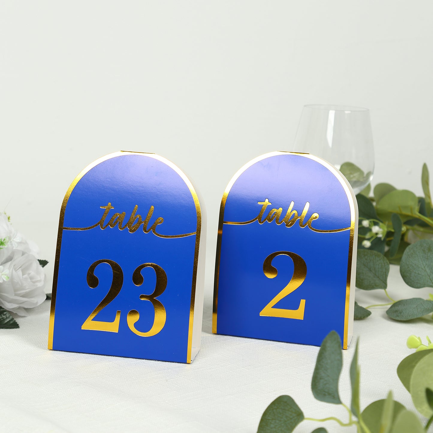 Royal blue disposable table numbers with metallic gold foil, numbers 1-25.
