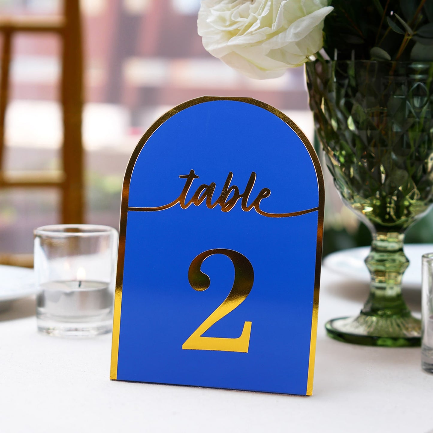 Royal blue disposable table number card with metallic gold foil, showing number 2.