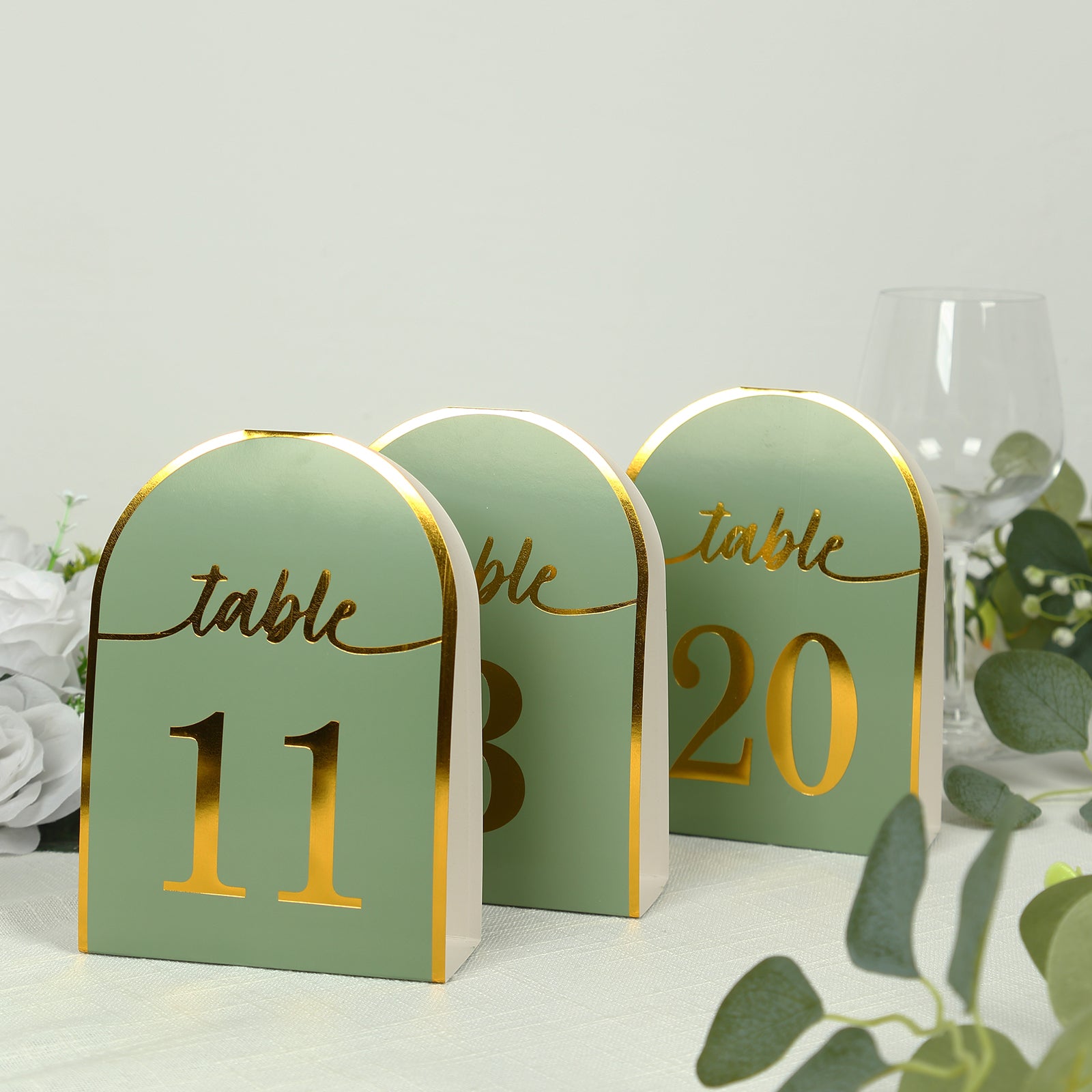 Sage green table numbers with metallic gold foil, 11, 13, and 20.