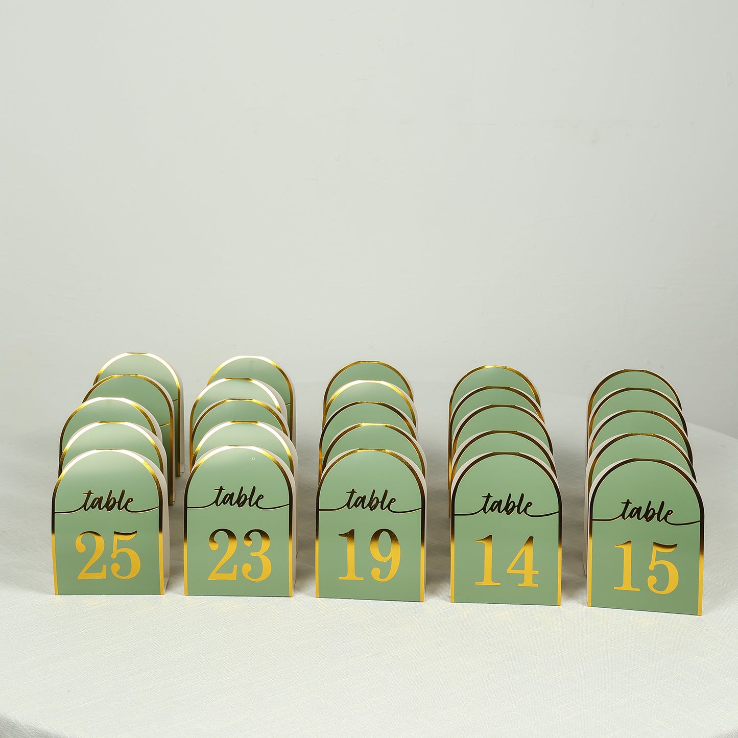 Sage green disposable table numbers with metallic gold foil numbers 1-25.