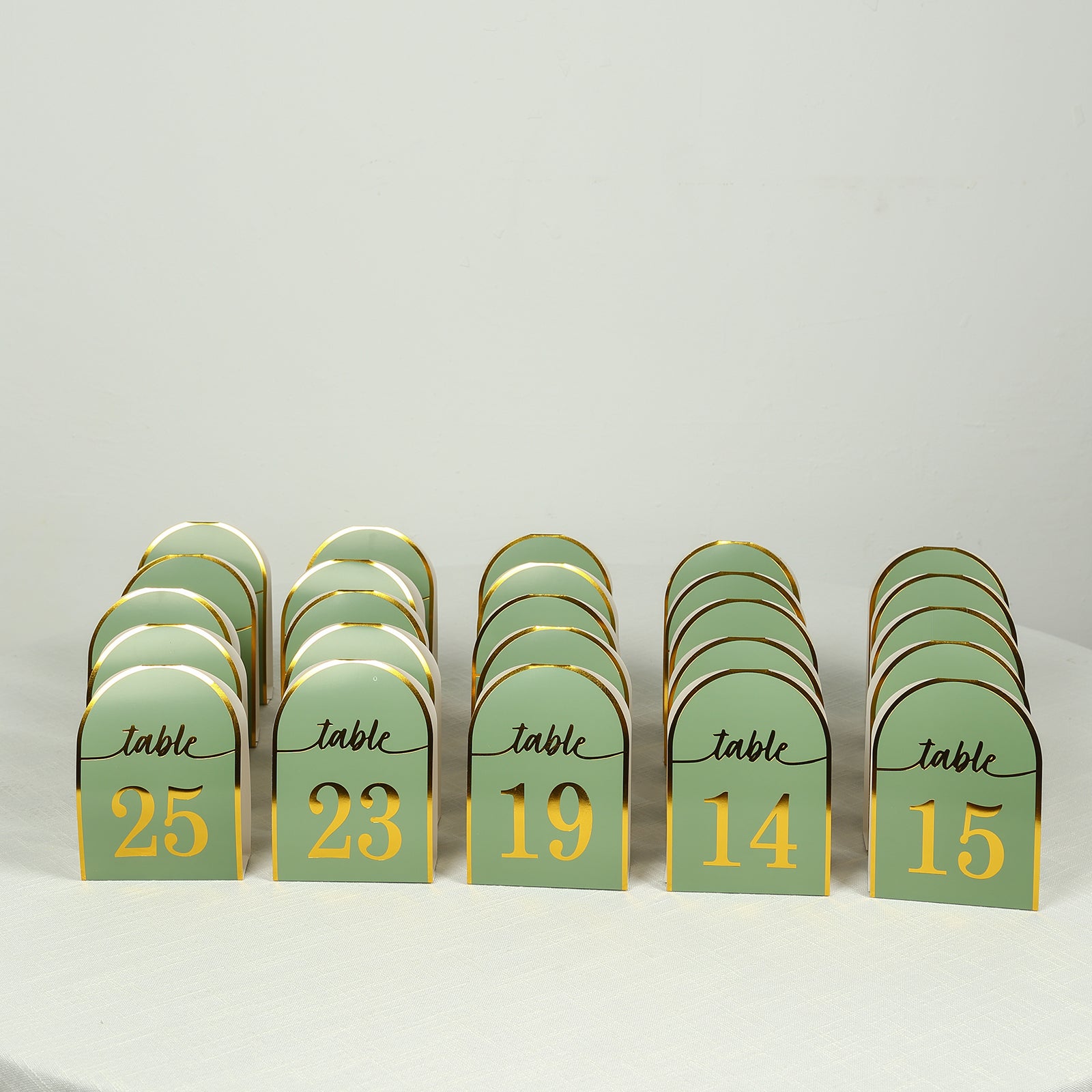 Sage green disposable table numbers with metallic gold foil numbers 1-25.